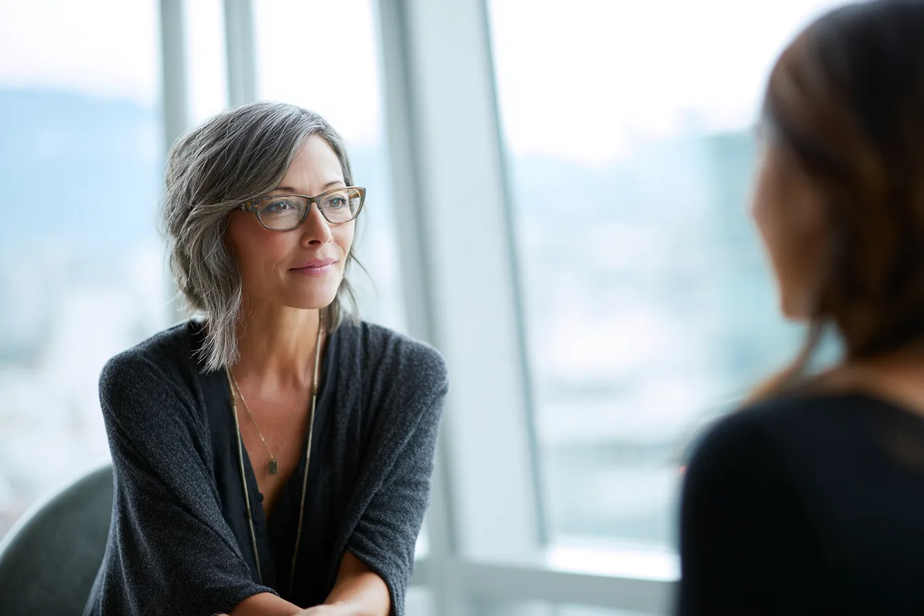 A leader listening, shot past the shoulder of the other person